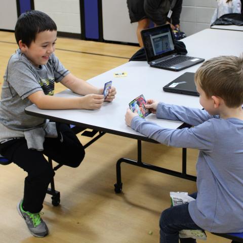 Two children playing cards 