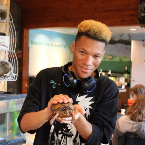 Student holding tortoise 