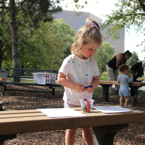 Child coloring outside 