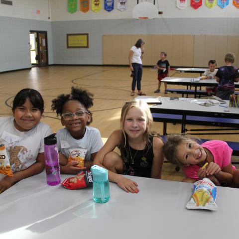 Children sitting at lunch table 